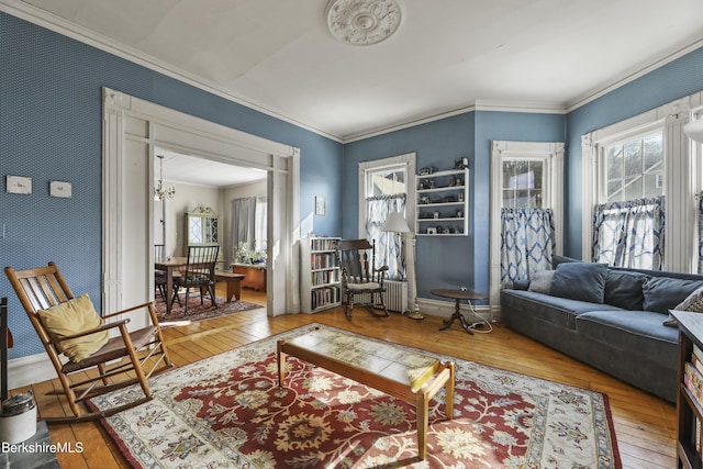 living room featuring wallpapered walls, crown molding, and wood-type flooring