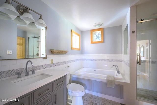 full bathroom with vanity, plus walk in shower, tile walls, and toilet