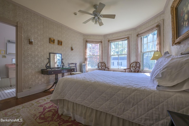 bedroom with hardwood / wood-style floors, ceiling fan, and crown molding