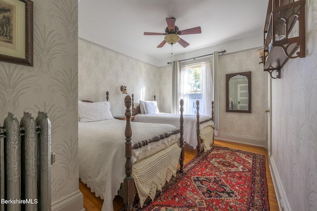 bedroom with hardwood / wood-style flooring and ceiling fan