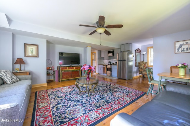 living room with wood-type flooring and ceiling fan