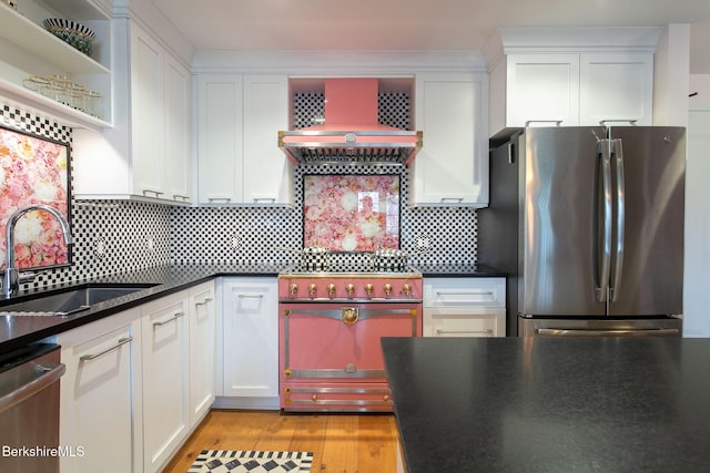 34 Bridge St, Great Barrington, MA 01230 - kitchen with stainless steel appliances, wall chimney exhaust hood, white cabinets, and dark countertops