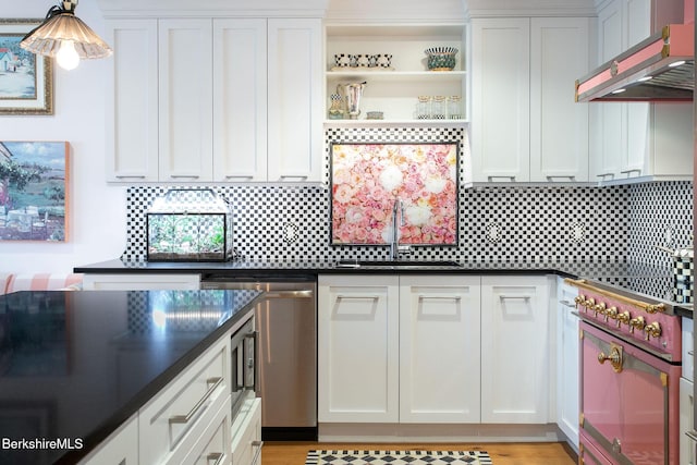 34 Bridge St, Great Barrington, MA 01230 - kitchen with exhaust hood, stainless steel dishwasher, dark countertops, and stovetop