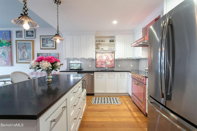 34 Bridge St, Great Barrington, MA 01230 - kitchen featuring appliances with stainless steel finishes, dark countertops, open shelves, white cabinets, and decorative backsplash