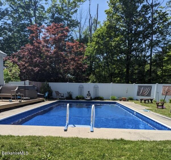 view of pool with a hot tub