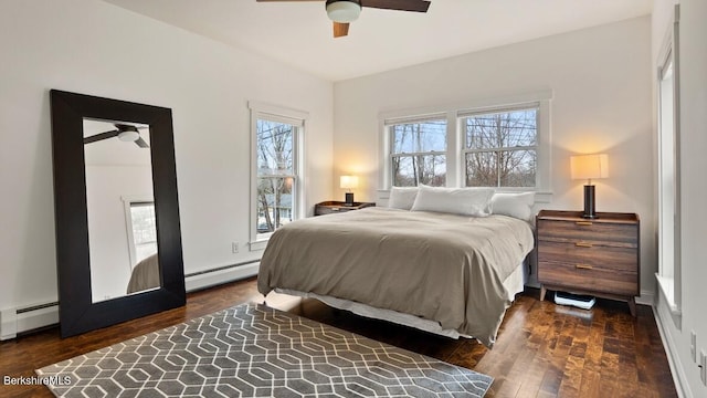 bedroom with a baseboard heating unit, wood-type flooring, and ceiling fan