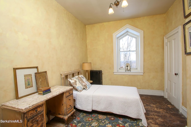 bedroom featuring radiator and dark hardwood / wood-style floors