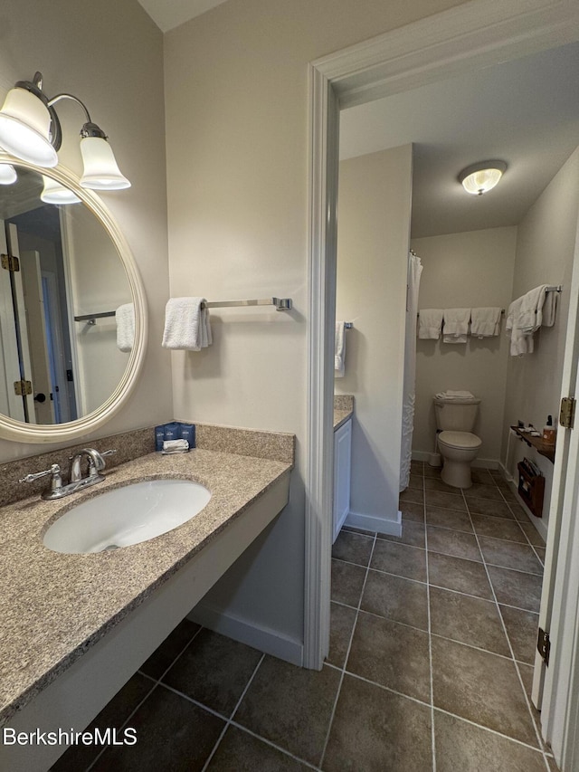 full bath featuring baseboards, vanity, toilet, and tile patterned floors