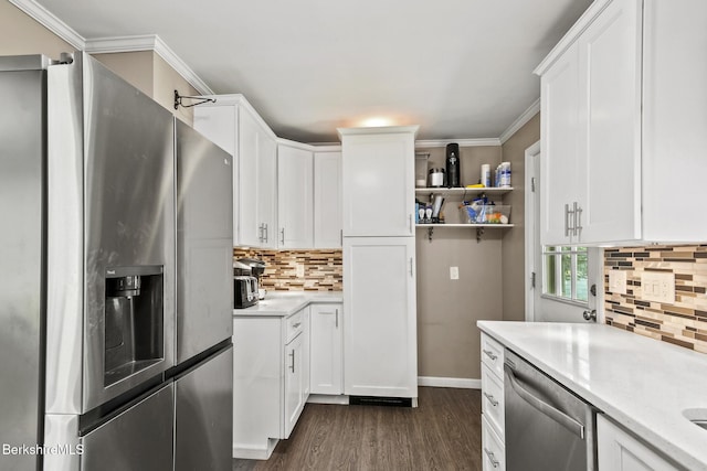 68 Tower Rd, Dalton, MA 01226 - kitchen with appliances with stainless steel finishes, light countertops, dark wood-style floors, decorative backsplash, and ornamental molding