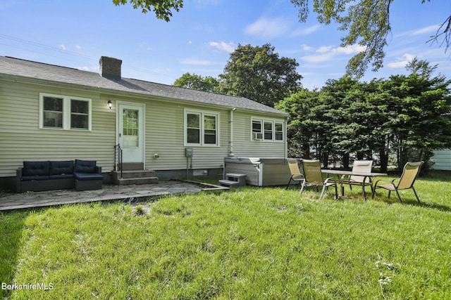 68 Tower Rd, Dalton, MA 01226 - rear view of property featuring entry steps, a hot tub, a lawn, a chimney, and a patio
