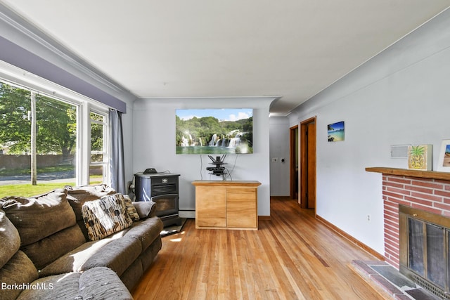 68 Tower Rd, Dalton, MA 01226 - living room with light wood-type flooring, a wood stove, and a brick fireplace
