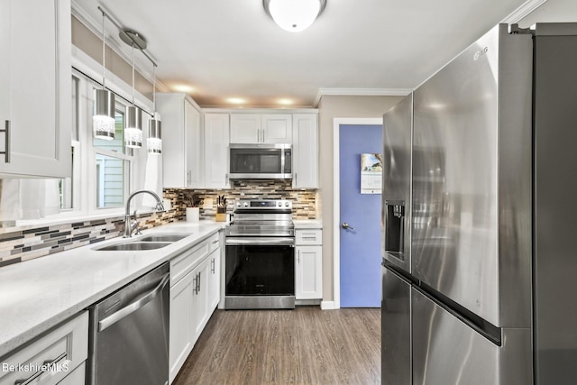 68 Tower Rd, Dalton, MA 01226 - kitchen featuring stainless steel appliances, wood finished floors, white cabinetry, decorative backsplash, and ornamental molding