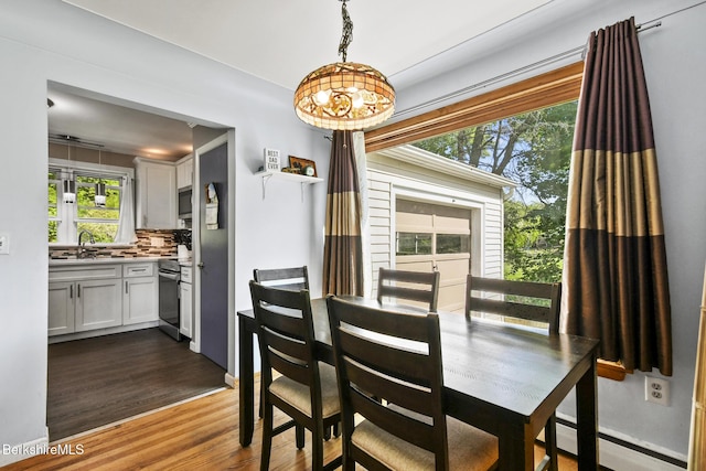 68 Tower Rd, Dalton, MA 01226 - dining room featuring a baseboard radiator, dark wood-style floors, plenty of natural light, and a chandelier