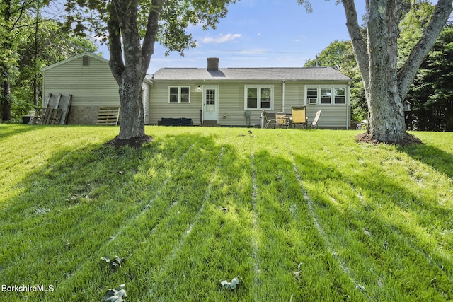 68 Tower Rd, Dalton, MA 01226 - back of house with a chimney, a lawn, and entry steps
