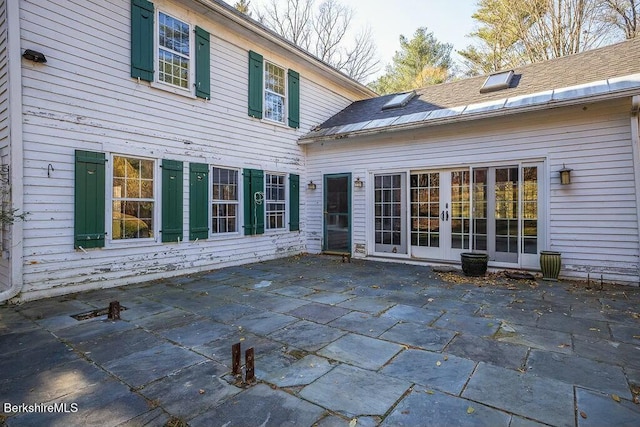 rear view of property featuring a patio area and french doors