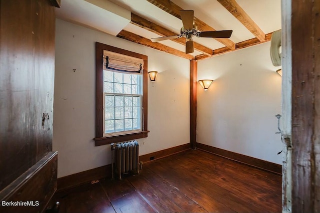 unfurnished room featuring beamed ceiling, radiator, dark wood-type flooring, and ceiling fan