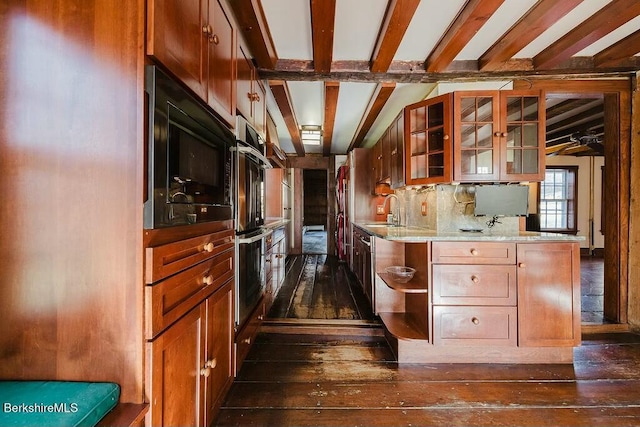 kitchen featuring built in microwave, sink, backsplash, dark wood-type flooring, and beam ceiling