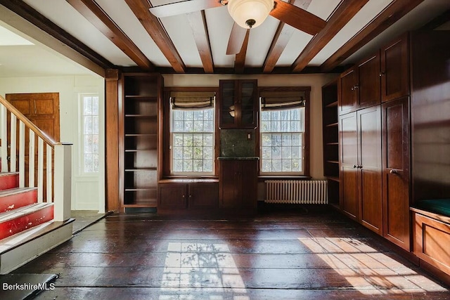 interior space with beam ceiling, radiator heating unit, dark hardwood / wood-style floors, and ceiling fan