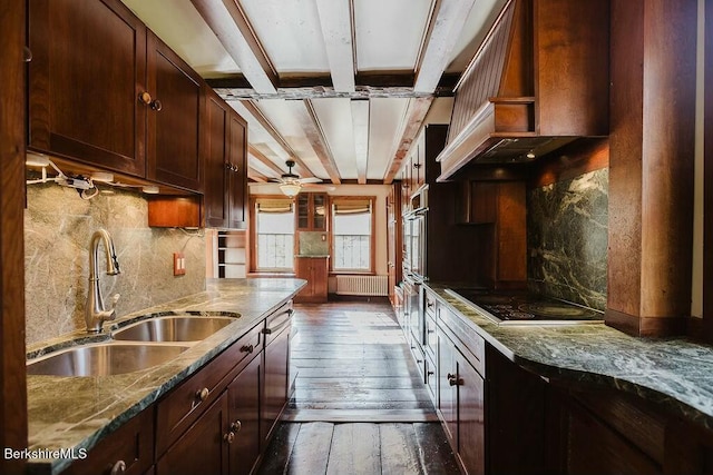 kitchen featuring premium range hood, sink, radiator heating unit, dark hardwood / wood-style flooring, and light stone countertops