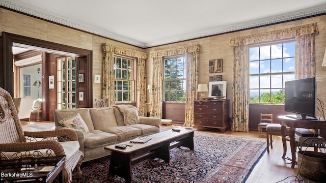 living area featuring light hardwood / wood-style floors and crown molding