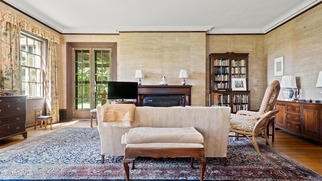 living area featuring crown molding and wood-type flooring