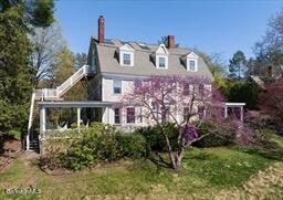 view of front of house featuring a chimney