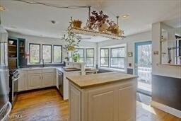 kitchen with a center island, light countertops, and wood finished floors