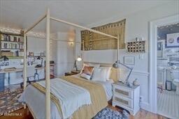 bedroom with a wainscoted wall