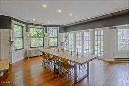 dining area with recessed lighting, radiator, and wood finished floors