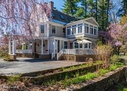 rear view of property featuring a patio and a chimney