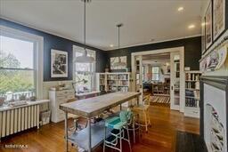 dining space featuring radiator heating unit, recessed lighting, and wood finished floors