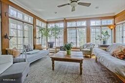 sunroom featuring crown molding and french doors