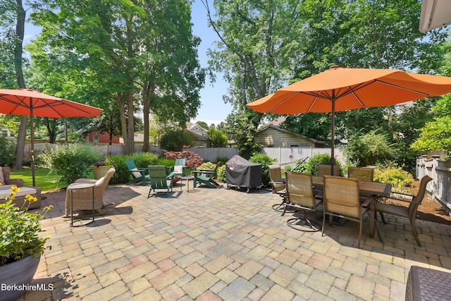 view of patio featuring a fenced backyard, outdoor dining space, and area for grilling