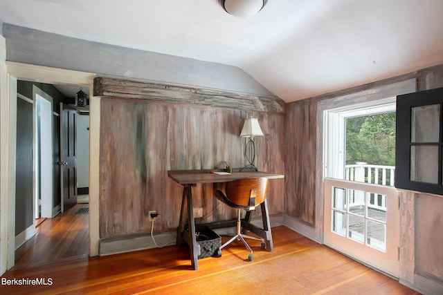 office space featuring hardwood / wood-style floors and vaulted ceiling