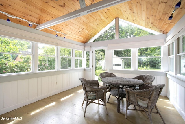 sunroom featuring vaulted ceiling with beams, wood ceiling, and track lighting