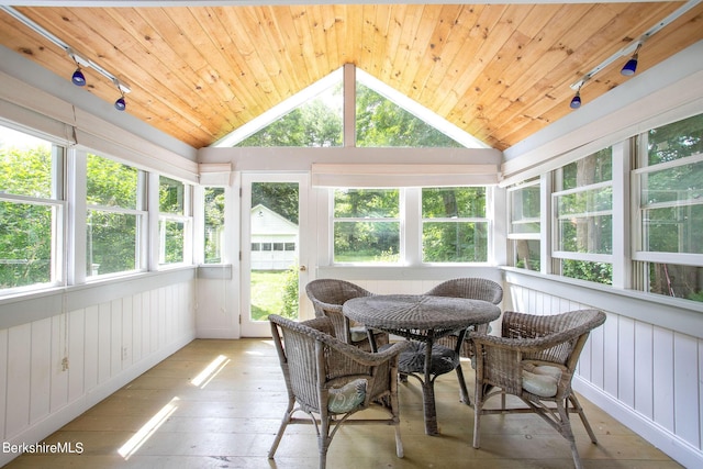 sunroom with rail lighting, wooden ceiling, and vaulted ceiling