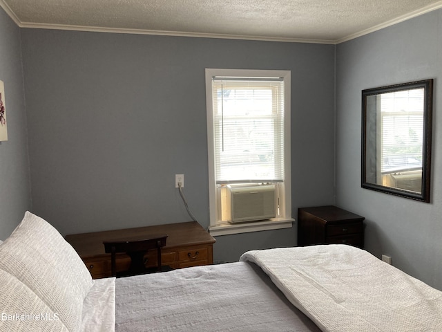 bedroom with crown molding, a textured ceiling, and cooling unit