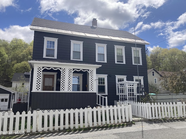 view of front of home featuring a fenced front yard, a porch, and a chimney