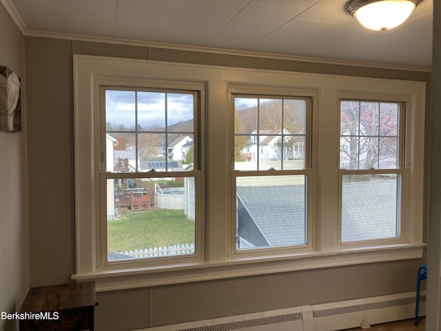 detailed view of crown molding and a baseboard radiator