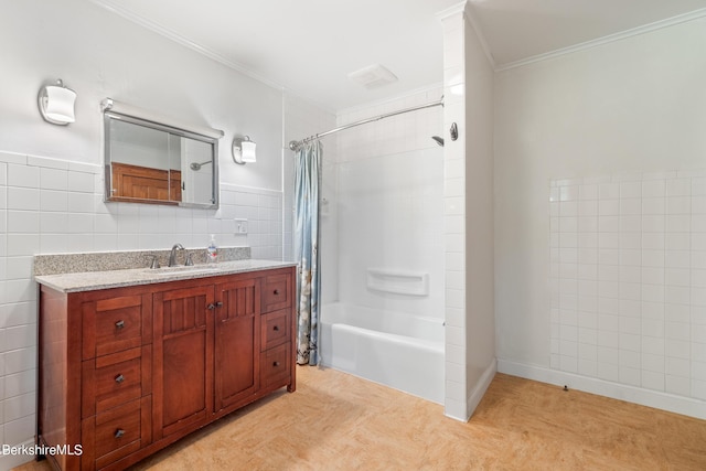 bathroom with shower / bath combination with curtain, vanity, tile walls, and ornamental molding