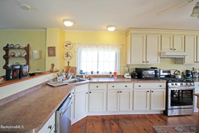 196 Huntington Rd, Worthington, MA 01098 - kitchen with stainless steel appliances, under cabinet range hood, ornamental molding, and dark wood finished floors