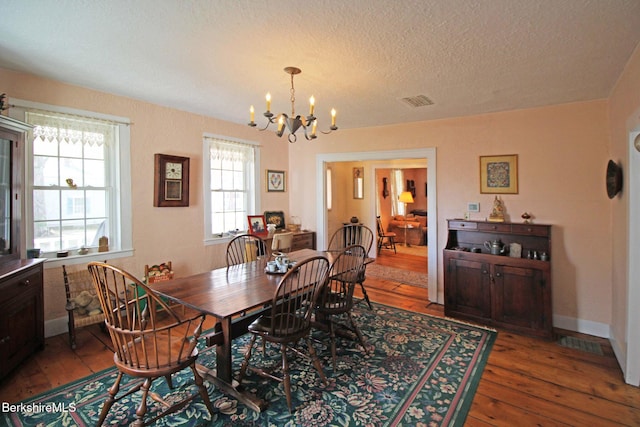 196 Huntington Rd, Worthington, MA 01098 - dining room with hardwood / wood-style flooring, a chandelier, and a textured ceiling