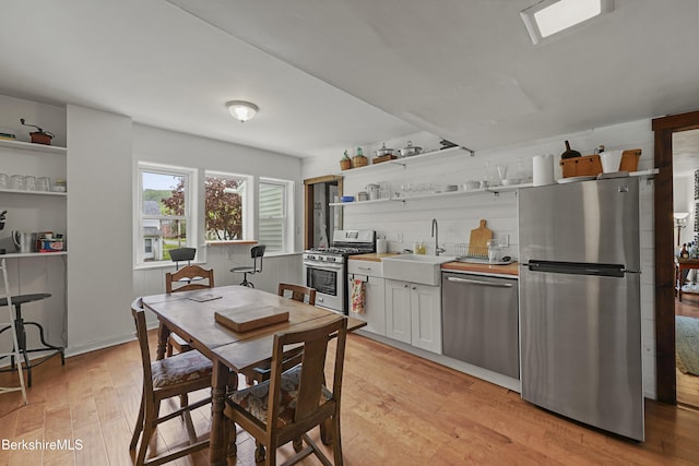 203 Main St, Hancock, MA 01237 - kitchen with stainless steel appliances, open shelves, a sink, light wood-type flooring, and white cabinets