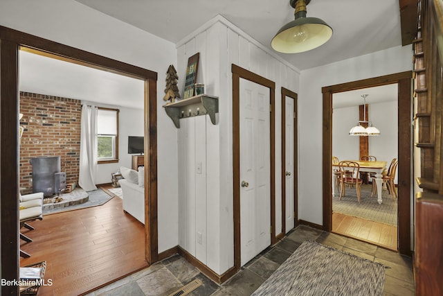 203 Main St, Hancock, MA 01237 - foyer featuring baseboards, a wood stove, and dark stone finish flooring