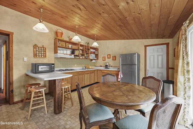 203 Main St, Hancock, MA 01237 - kitchen with appliances with stainless steel finishes, open shelves, light countertops, under cabinet range hood, and wood ceiling