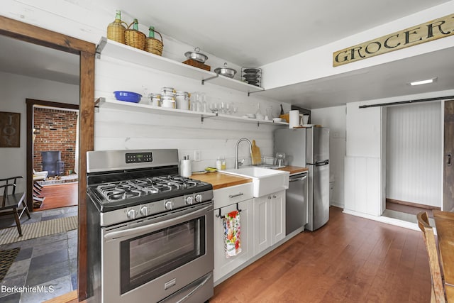 203 Main St, Hancock, MA 01237 - kitchen with stainless steel appliances, a sink, wood counters, open shelves, and dark wood finished floors