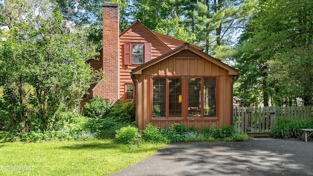 147 Hurlburt Rd, Great Barrington, MA 01230 - view of front facade featuring board and batten siding and a chimney