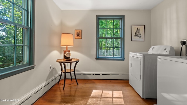 147 Hurlburt Rd, Great Barrington, MA 01230 - washroom featuring washing machine and dryer, a baseboard radiator, and wood finished floors