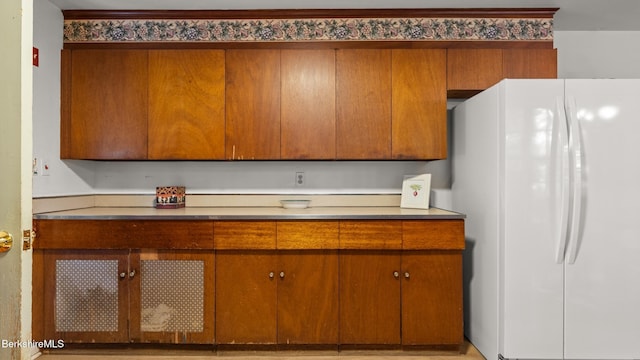 147 Hurlburt Rd, Great Barrington, MA 01230 - kitchen featuring freestanding refrigerator, brown cabinetry, and light countertops