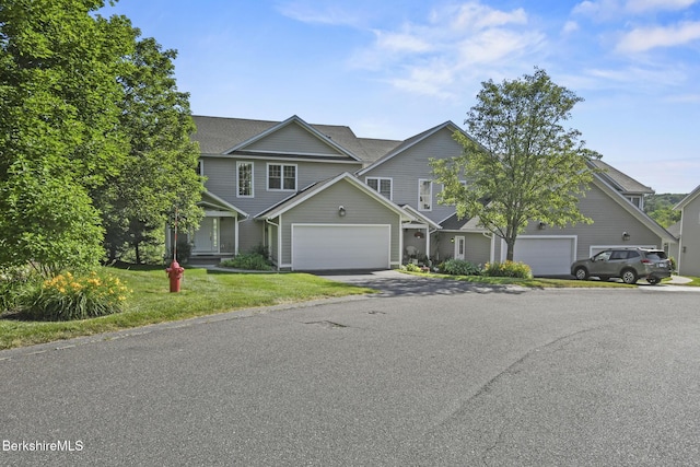 12 Alpine Trl Unit 12, Pittsfield, MA 01201 - view of front of house with asphalt driveway, a front lawn, an attached garage, and roof with shingles